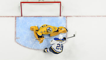 Mar 27, 2025; Nashville, Tennessee, USA;  Nashville Predators goaltender Juuse Saros (74) blocks the shot of St. Louis Blues center Jordan Kyrou (25) during the third period at Bridgestone Arena. Mandatory Credit: Steve Roberts-Imagn Images