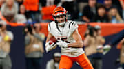 Sep 29, 2025; Denver, Colorado, USA;  Cincinnati Bengals wide receiver Charlie Jones (15) runs after making a catch as Denver Broncos cornerback Kris Abrams-Draine (31) defends during the second quarter at Empower Field at Mile High. Mandatory Credit: Isaiah J. Downing-Imagn Images