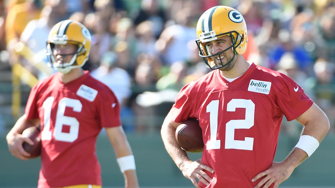 Jul 30, 2015; Green Bay, WI, USA;  Green Bay Packers quarterbacks Aaron Rodger (12) and Scott Tolzien (16) practice during training camp at Ray Nitschke Field. Mandatory Credit: Benny Sieu-Imagn Images