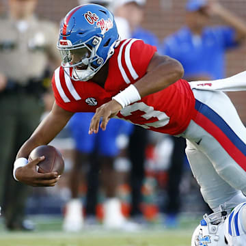 Sep 7, 2024; Oxford, Mississippi, USA; Mississippi Rebels quarterback Austin Simmons (13) dives forward as he is tackled by Middle Tennessee Blue Raiders defensive back Rickey Smith (27) during the second half at Vaught-Hemingway Stadium. Mandatory Credit: Petre Thomas-Imagn Images