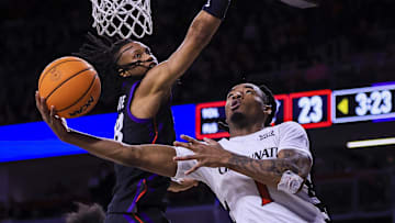 Feb 22, 2025; Cincinnati, Ohio, USA; Cincinnati Bearcats guard Day Day Thomas (1) shoots against TCU Horned Frogs forward Trazarien White (13) in the first half at Fifth Third Arena. Mandatory Credit: Katie Stratman-Imagn Images