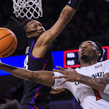 Feb 22, 2025; Cincinnati, Ohio, USA; Cincinnati Bearcats guard Day Day Thomas (1) shoots against TCU Horned Frogs forward Trazarien White (13) in the first half at Fifth Third Arena. Mandatory Credit: Katie Stratman-Imagn Images