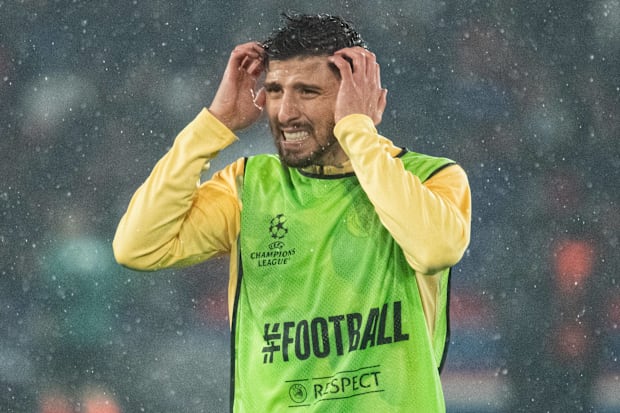 Rúben Dias looking pained while warming up for Manchester City