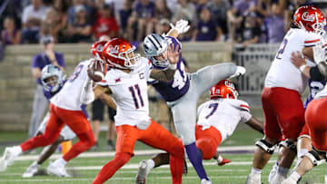 Sep 13, 2024; Manhattan, Kansas, USA; Arizona Wildcats quarterback Noah Fifita (11) passes the ball while being rushed by Kansas State Wildcats linebacker Austin Moore (41) at Bill Snyder Family Football Stadium. Mandatory Credit: Scott Sewell-Imagn Images