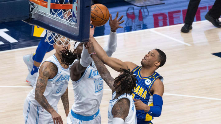 May 15, 2021; Indianapolis, Indiana, USA; Indiana Pacers guard Edmond Sumner (5) shoots the ball while Los Angeles Lakers center Montrezl Harrell (15) defends in the second  quarter at Bankers Life Fieldhouse. Mandatory Credit: Trevor Ruszkowski-USA TODAY Sports