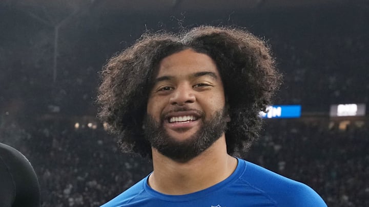 Indianapolis Colts defensive end Jaylahn Tuimoloau exchanges jerseys