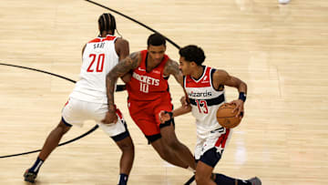 Nov 11, 2024; Houston, Texas, USA;  Washington Wizards forward Alexandre Sarr (20) sets a pick for guard Jordan Poole (13) against Houston Rockets forward Jabari Smith Jr. (10) in the second half at Toyota Center. Mandatory Credit: Thomas Shea-Imagn Images