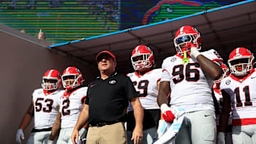 Georgia Bulldogs head coach Kirby Smart, center, prepares to lead the team onto the field before an NCAA football game Saturday, Oct. 28, 2023.