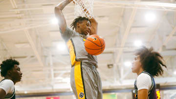 Team Thad’s Jamarion Davis-Fleming (24) dunks the ball against Team Oak Soldiers’ Chad Traviar (1) during the Nike Elite Youth Basketball League session one on Saturday, April 27, 2024 at the Memphis Sports & Event Center in Memphis, Tenn.