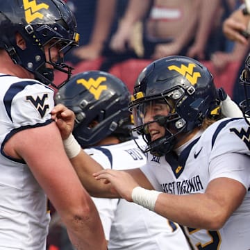 Nov 1, 2025; Houston, Texas, USA; West Virginia Mountaineers quarterback Scotty Fox Jr. (15) celebrates his touchdown with teammates against the Houston Cougars  in the second half at TDECU Stadium. Mandatory Credit: Thomas Shea-Imagn Images
