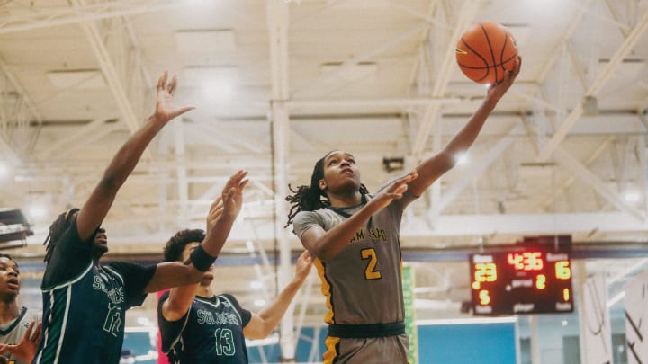 Team Thad’s Jasper Johnson (2) lays the ball up against Team Oak Soldiers’ Doug Langford (13) during the Nike Elite Youth Basketball League session one on Saturday, April 27, 2024 at the Memphis Sports & Event Center in Memphis, Tenn.