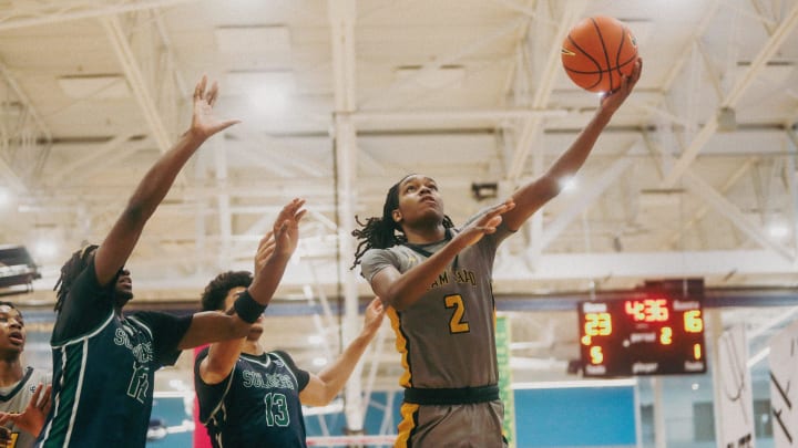 Team Thad’s Jasper Johnson (2) lays the ball up against Team Oak Soldiers’ Doug Langford (13) during the Nike Elite Youth Basketball League session one on Saturday, April 27, 2024 at the Memphis Sports & Event Center in Memphis, Tenn.