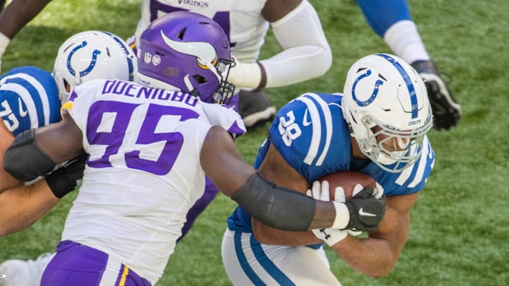Sep 20, 2020; Indianapolis, Indiana, USA; Indianapolis Colts running back Jonathan Taylor (28) runs the ball while Minnesota Vikings defensive end Ifeadi Odenigbo (95) defends in the first quarter at Lucas Oil Stadium. Mandatory Credit: Trevor Ruszkowski-Imagn Images