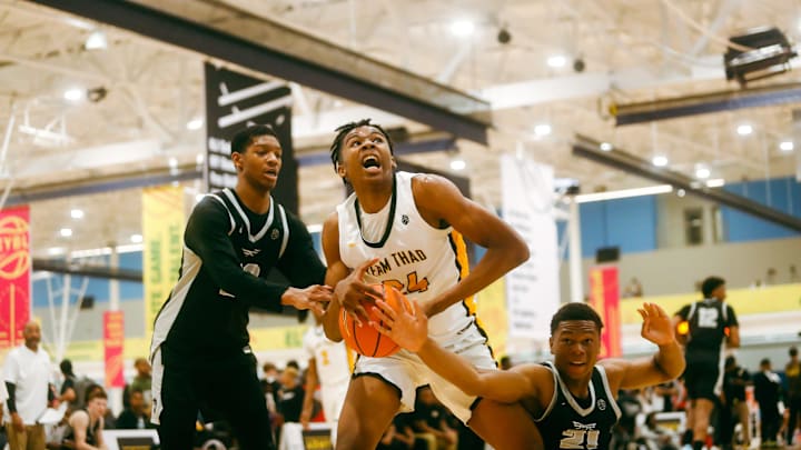 Team Thad’s Jamarion Davis-Fleming (24) secures a rebound against Team Bradley Beal Elite’s Christian Brown (21) during the Nike Elite Youth Basketball League session one on Friday, April 26, 2024 at the Memphis Sports & Event Center in Memphis, Tenn.