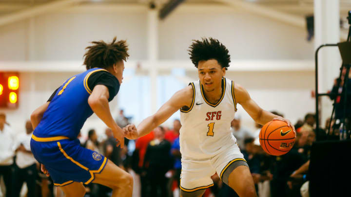 Team SFG’s Brayden Burries (1) looks to make a play against Team Boo Williams during the Nike Elite Youth Basketball League. 