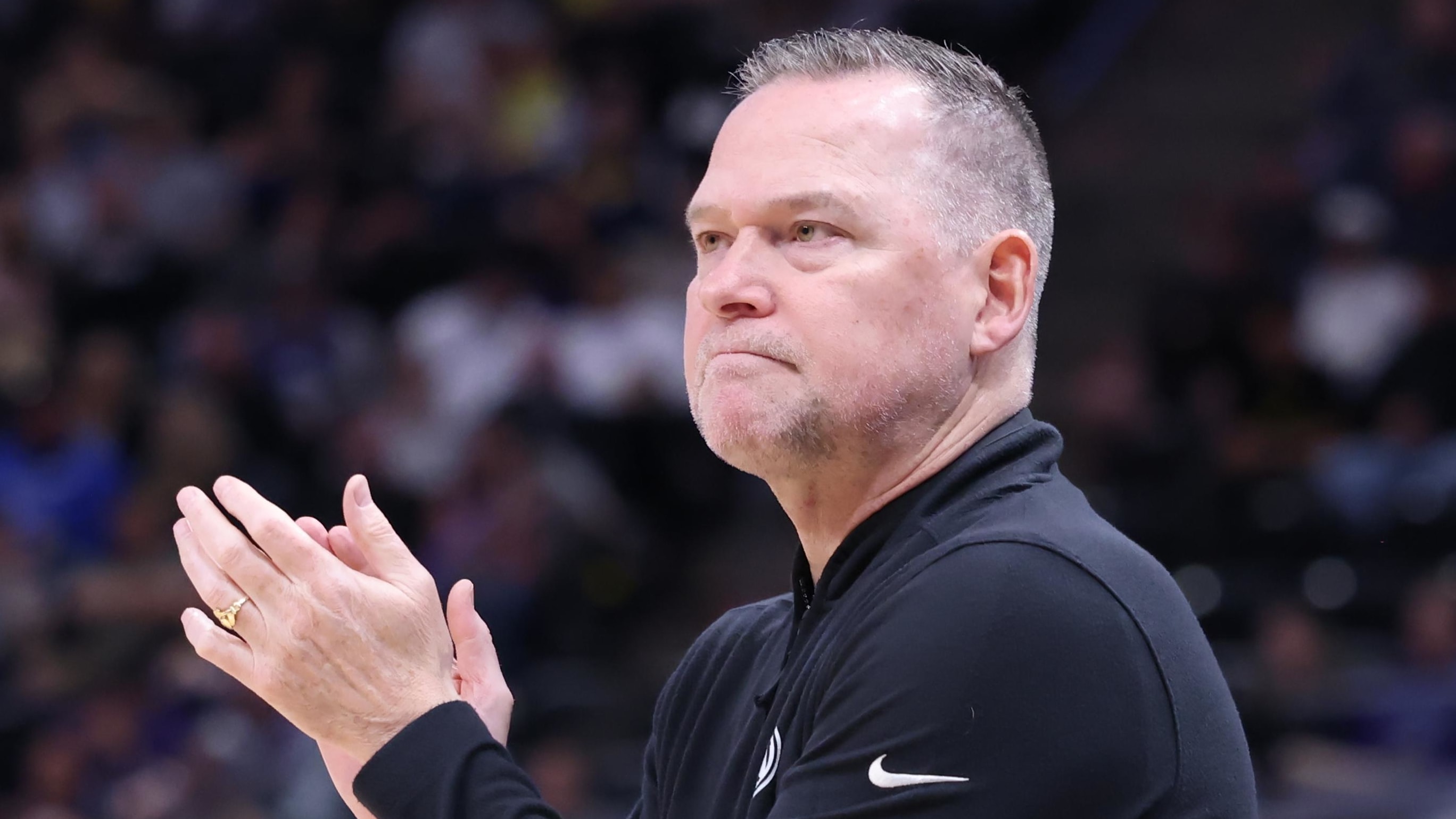 Pelicans coach Willie Green chats with a referee.