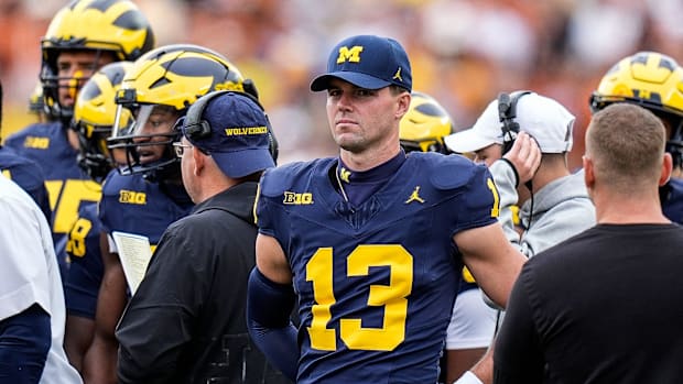 Michigan quarterback Jack Tuttle (13) at a timeout against Texas during the first half at Michigan Stadium in Ann Arbor on Sa