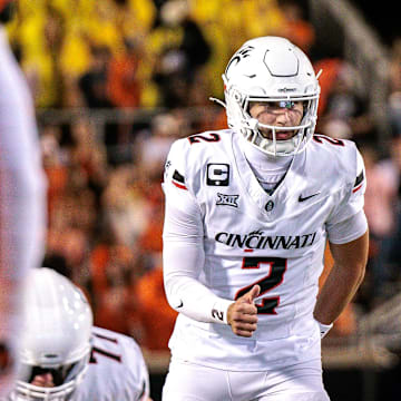 Oct 18, 2025; Stillwater, Oklahoma, USA; Cincinnati Bearcats quarterback Brendan Sorsby (2) behind the line during the first half against the Oklahoma State Cowboys  at Boone Pickens Stadium. Mandatory Credit: William Purnell-Imagn Images