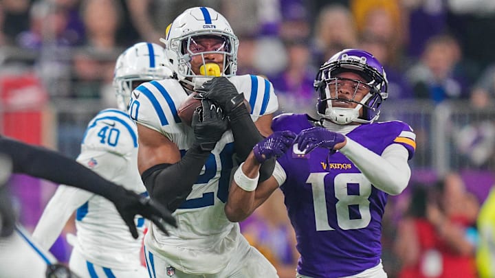 Nov 3, 2024; Minneapolis, Minnesota, USA; Indianapolis Colts safety Nick Cross (20) intercpets a pass against the Minnesota Vikings quarterback Sam Darnold (14) in the fourth quarter at U.S. Bank Stadium. Mandatory Credit: Brad Rempel-Imagn Images