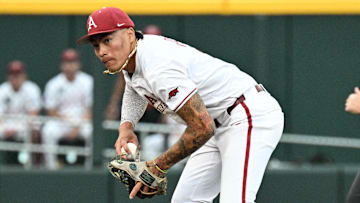 Arkansas Razorbacks shortstop Wehiwa Aloy (9) fields a ground ball against the UCLA Bruins during the sixth inning at Charles Schwab Field.