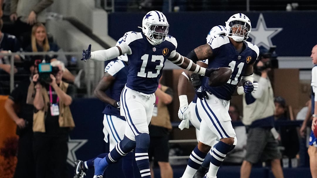 Nov 28, 2024; Arlington, Texas, USA;  Dallas Cowboys linebacker DeMarvion Overshown (13) celebrates after scoring on a touchdown interception against the New York Giants during the first half at AT&T Stadium. Mandatory Credit: Chris Jones-Imagn Images