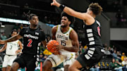 Jan 7, 2025; Waco, Texas, USA;  Baylor Bears forward Norchad Omier (15) drives to the basket between Cincinnati Bearcats guard Jizzle James (2) and guard Dan Skillings Jr. (0) during the first half at Paul and Alejandra Foster Pavilion. Mandatory Credit: Chris Jones-Imagn Images