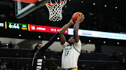 Jan 7, 2025; Waco, Texas, USA;  Baylor Bears forward Josh Ojianwuna (17) scores a basket as Cincinnati Bearcats guard Day Day Thomas (1) defends during the first half at Paul and Alejandra Foster Pavilion. Mandatory Credit: Chris Jones-Imagn Images