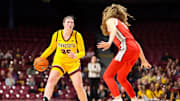 Feb 8, 2024; Minneapolis, Minnesota, USA; Minnesota Golden Gophers guard Grace Grocholski (25) dribbles as Ohio State Buckeyes guard Emma Shumate (5) defends during the first half at Williams Arena. Mandatory Credit: Matt Krohn-Imagn Images