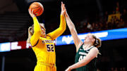 Jan 20, 2024; Minneapolis, Minnesota, USA; Minnesota Golden Gophers center Sophie Hart (52) shoots as Michigan State Spartans guard Julia Ayrault (40) defends during the first half at Williams Arena. Mandatory Credit: Matt Krohn-Imagn Images