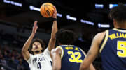 Penn State Nittany Lions forward Puff Johnson shoots as Michigan Wolverines forward Tarris Reed Jr. defends during the second half at Target Center.