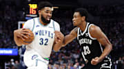 Feb 24, 2024; Minneapolis, Minnesota, USA; Minnesota Timberwolves center Karl-Anthony Towns (32) works around Brooklyn Nets center Nic Claxton (33) during the first half at Target Center. Mandatory Credit: Matt Krohn-USA TODAY Sports