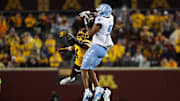 Aug 29, 2024; Minneapolis, Minnesota, USA; North Carolina Tar Heels wide receiver J.J. Jones (5) drops a pass as Minnesota Golden Gophers defensive back Za'Quan Bryan (4) defends during the second half at Huntington Bank Stadium. 