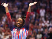 Jun 30, 2024; Minneapolis, Minnesota, USA; Simone Biles celebrates her floor routine during the U.S. Olympic Team Gymnastics Trials at Target Center. 
