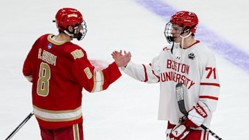 Apr 11, 2024; Saint Paul, Minnesota, USA; Boston University Terriers forward Macklin Celebrini (71) and Denver Pioneers defenseman Shai Buium (8) shake hands after the game in the semifinals of the 2024 Frozen Four college ice hockey tournament at Xcel Energy Center. Mandatory Credit: Matt Krohn-Imagn Images