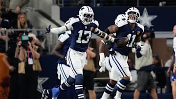 Nov 28, 2024; Arlington, Texas, USA;  Dallas Cowboys linebacker DeMarvion Overshown (13) celebrates after scoring on a touchdown interception against the New York Giants during the first half at AT&T Stadium. Mandatory Credit: Chris Jones-Imagn Images