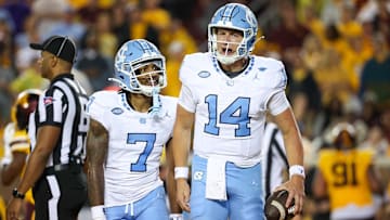 Aug 29, 2024; Minneapolis, Minnesota, USA; North Carolina Tar Heels quarterback Max Johnson (14) celebrates his rushing touchdown against the Minnesota Golden Gophers during the first half at Huntington Bank Stadium. Mandatory Credit: Matt Krohn-Imagn Images