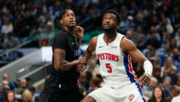 Apr 12, 2024; Dallas, Texas, USA; Dallas Mavericks forward Olivier-Maxence Prosper (18) and Detroit Pistons forward Chimezie Metu (5) battle for position during the first half at American Airlines Center. Mandatory Credit: Chris Jones-Imagn Images