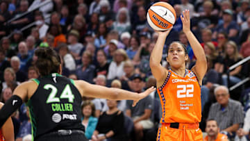 Sep 29, 2024; Minneapolis, Minnesota, USA; Connecticut Sun guard Veronica Burton (22) shoots as Minnesota Lynx forward Napheesa Collier (24) defends during the first half of game one of the 2024 WNBA Semi-finals at Target Center. Mandatory Credit: Matt Krohn-Imagn Images