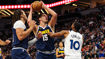 Nov 1, 2023; Minneapolis, Minnesota, USA; Denver Nuggets center Nikola Jokic (15) looks to shoot while Minnesota Timberwolves guard Mike Conley (10) defends during the first half at Target Center. Mandatory Credit: Matt Krohn-USA TODAY Sports