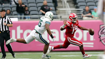 Dec 15, 2018; Orlando, FL, USA; Louisiana-Lafayette Ragin Cajuns quarterback Levi Lewis (17) runs out of the pocket as Tulane Green Wave linebacker Lawrence Graham (35) defends during the second half at Camping World Stadium. Mandatory Credit: 