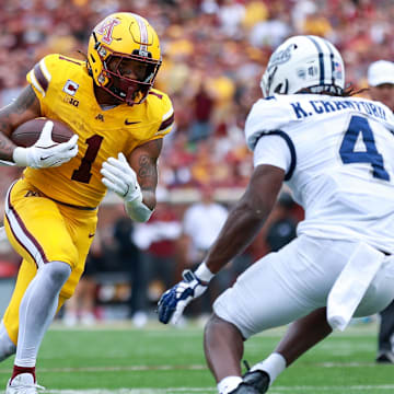 Sep 14, 2024; Minneapolis, Minnesota, USA; Minnesota Golden Gophers running back Darius Taylor (1) runs the ball as Nevada Wolf Pack safety Kitan Crawford (4) defends during the first half at Huntington Bank Stadium. Mandatory Credit: Matt Krohn-Imagn Images