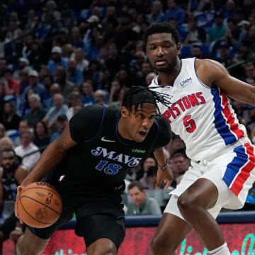 Apr 12, 2024; Dallas, Texas, USA; Dallas Mavericks forward Olivier-Maxence Prosper (18) drives to the basket past Detroit Pistons forward Chimezie Metu (5) during the first half at American Airlines Center. Mandatory Credit: Chris Jones-USA TODAY Sports