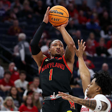 Maryland Terrapins guard Jahmir Young (1) shoots as Wisconsin Badgers guard Kamari McGee (4) defends. Mandatory Credit: Matt Krohn-Imagn Images