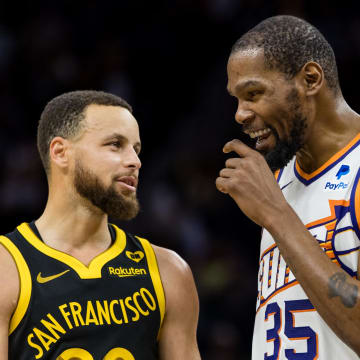 San Francisco, California, USA; Golden State Warriors guard Stephen Curry (30) and Phoenix Suns forward Kevin Durant (35) talk during the second half at Chase Center. Mandatory Credit: