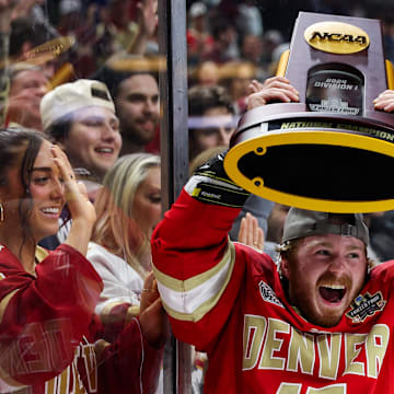 Denver Pioneers forward Peter LaJoy celebrates with the trophy after his teams win against the Boston College Eagles after the championship game of the 2024 Frozen Four college ice hockey tournament at Xcel Energy Center.