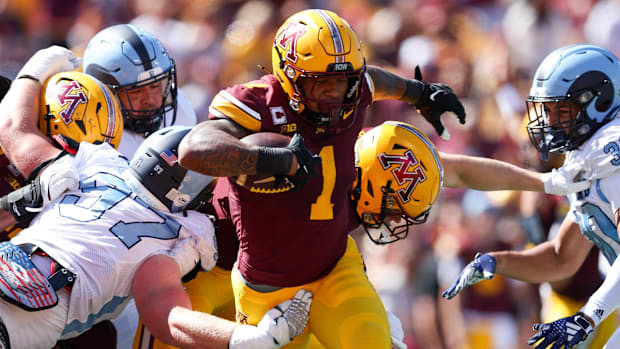 Minnesota Golden Gophers running back Darius Taylor (1) runs for a touchdown against the Rhode Island Rams during the first h