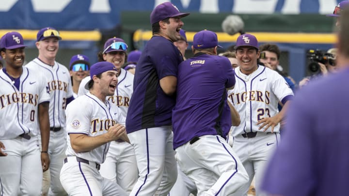 May 25, 2024; Hoover, AL, USA; LSU Tigers players cheer as their head coach Jay Johnson returns to the field after his ejection to celebrates with them postgame following a 12-11 tenth inning walkoff win over the South Carolina Gamecocks during the SEC Baseball Tournament at Hoover Metropolitan Stadium. Mandatory Credit: Vasha Hunt-USA TODAY Sports