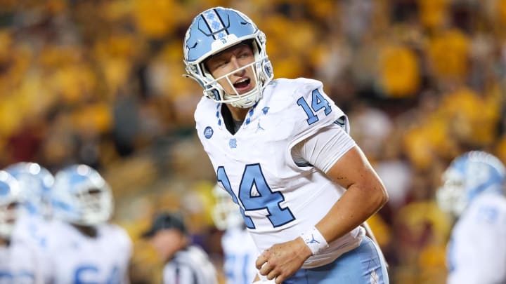 Aug 29, 2024; Minneapolis, Minnesota, USA; North Carolina Tar Heels quarterback Max Johnson (14) celebrates his rushing touchdown against the Minnesota Golden Gophers during the first half at Huntington Bank Stadium. Mandatory Credit: Matt Krohn-USA TODAY Sports