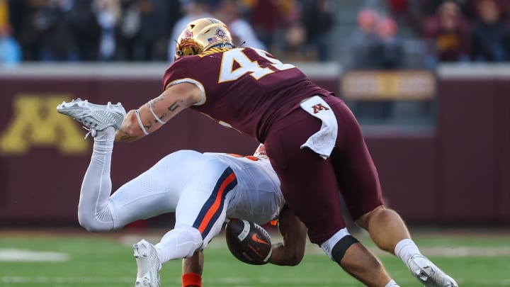 Nov 4, 2023; Minneapolis, Minnesota, USA; Minnesota Golden Gophers linebacker Cody Lindenberg (45) tackles Illinois Fighting Illini wide receiver Isaiah Williams (1) forcing a fumble during the second half at Huntington Bank Stadium. Mandatory Credit: Matt Krohn-USA TODAY Sports