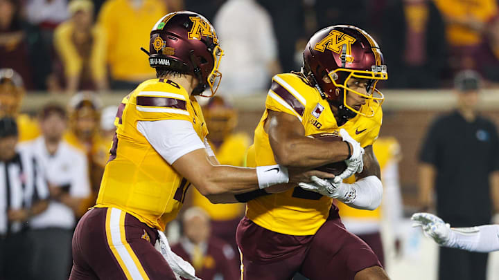 Aug 29, 2024; Minneapolis, Minnesota, USA; Minnesota Golden Gophers quarterback Max Brosmer (16) hands the ball off to wide receiver Daniel Jackson (9) during the first half against the North Carolina Tar Heels at Huntington Bank Stadium. Mandatory Credit: Matt Krohn-Imagn Images